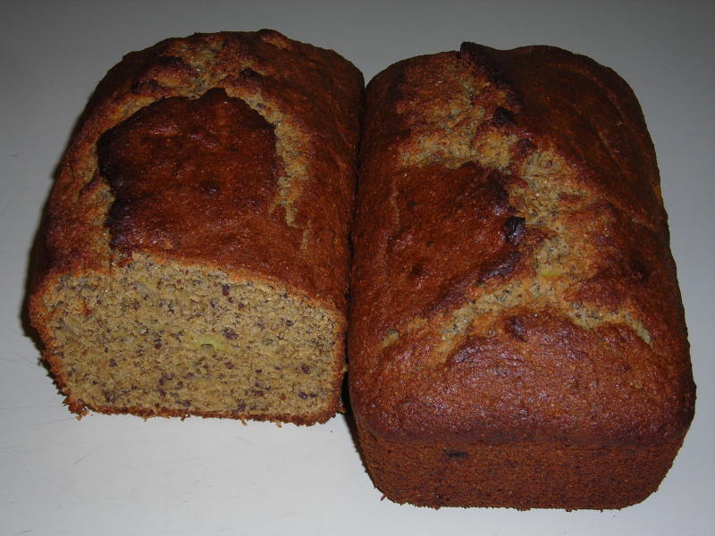 Two loaves of banana bread.  The end has been cut off of the one on the left.