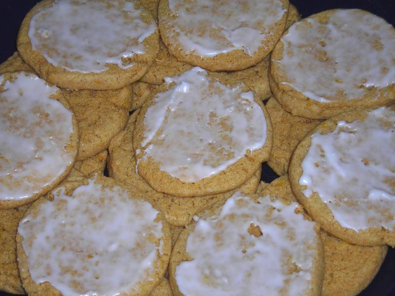 A pile of lemon cookies.  The cookies on the top layer have been frosted.